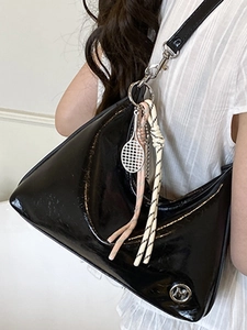 Fashionable black patent leather crescent hobo tote bag with stylish charms and silver logo