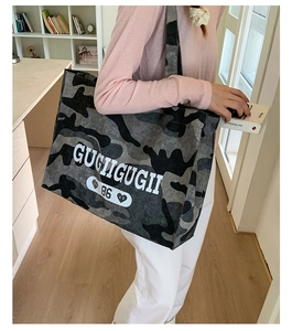 Detail view of durable camouflage tote bag with bold GUGIIGUGII lettering and 86 print