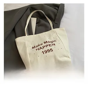 Detail of the high-quality canvas fabric texture and brown letter print on the tote bag