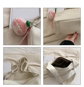 Detail shots of white faux leather tote bag with peach plush charm and wide strap