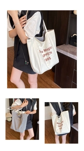Detail view of large canvas tote bag showing double-sided design and magic lettering