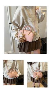 Pink glossy patent leather handbag with bear charm and adjustable shoulder strap