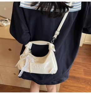 Off-white oil wax leather crossbody bag featuring fashion embossed detail and lace bow
