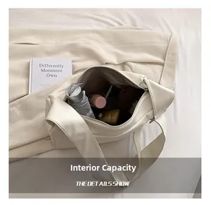 Internal capacity of the cream shoulder tote bag showing everyday essentials like an umbrella