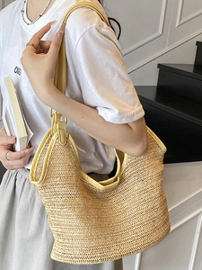 Chic woven straw tote bag with yellow leather trim for summer beach and vacation styling