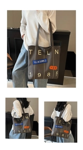 Detailed close-up showing the heavy canvas material and retro lettering on the tote bag