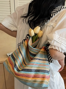 Large colorful woven straw tote bag with rainbow stripes for summer beach vacations