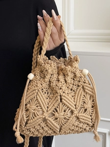 Minimalist woven straw bucket bag with macrame patterns and wooden beads for summer