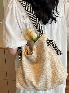 Large straw woven shoulder bag with striped strap for summer beach vacations