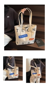 Close-up of cream canvas tote bag with letter prints on wooden stairs background