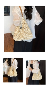 Close-up of hollow crochet texture and leather shoulder strap on a beige straw tote bag