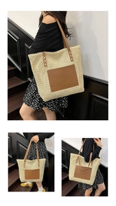 Detailed view of cream straw tote bag with brown leather pocket and woven shoulder straps