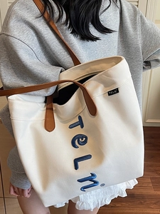 Large capacity cream canvas tote bag with brown leather straps and blue embroidery for women