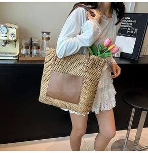 Detail of hand-woven straw tote bag with brown leather pocket and large capacity interior
