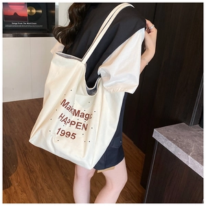 Detail view of large canvas tote bag with brown Make Magic HAPPEN artistic print