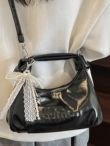 Fashionable black oil wax leather handbag with pearl lace bow charm shown on model