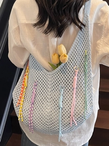 Light blue crochet shoulder bag with colorful tassels and hollow mesh design for summer