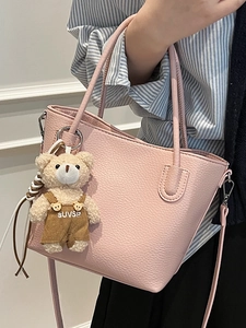 Pink lychee grain leather bucket bag with cute bear charm and thin shoulder strap