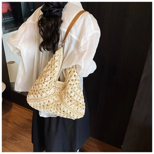 Fashionable beige woven tote bag with brown PU straps and hollow floral pattern details