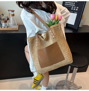 Detail showing high-capacity straw tote bag with brown leather pocket and mesh woven texture