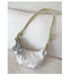 Detail of white PU leather dumpling bag with light green rope strap and star pendant