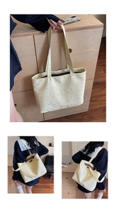Detail of light yellow tote bag with letter patterns and glossy faux leather texture