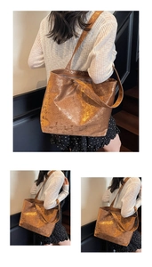 Detailed macro view of large metallic tote bag featuring vintage numbered print design