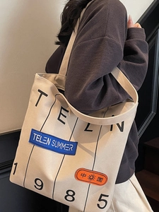 Large capacity canvas tote bag with vintage letter print and adjustable shoulder straps