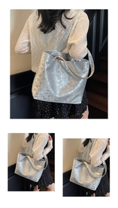 Macro view of metallic silver tote bag with large numeral prints and shoulder strap