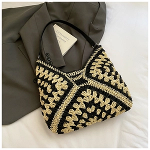 Detail showing the intricate floral knit pattern and premium leather strap of the woven tote
