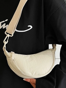Beige crescent nylon crossbody bag with adjustable wide strap for daily commute