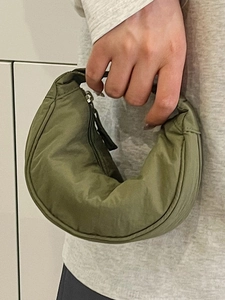 Olive green nylon crescent bag with waterproof texture and minimalist zip closure