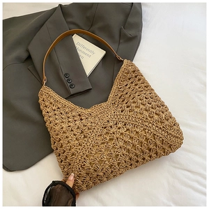 Detailed macro view of khaki hollow-out woven straw mesh fabric and brown leather handle