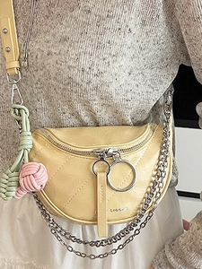Yellow quilted faux leather saddle bag with silver chain strap and knot tassel