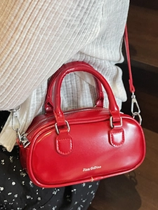 Glossy red Boston mini handbag with top handles and adjustable shoulder strap for women