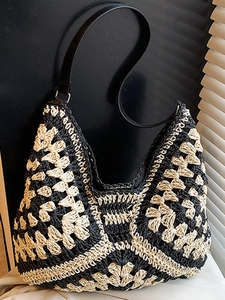 Handmade woven crochet hobo bag in black and beige contrast with floral patterns