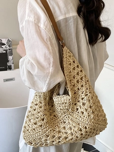 Chic beige crochet woven tote bag with brown leather straps for travel and beach use