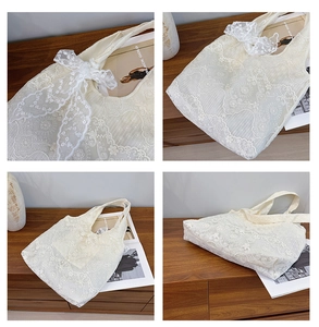 Close-up of white lace tote bag with large ribbon bow and intricate texture details