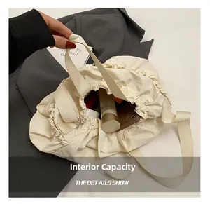 Internal capacity detail of cream drawstring canvas tote bag with ruffled edges