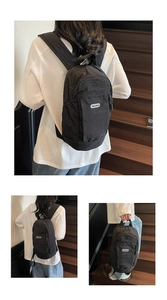 Close-up of black nylon backpack with Youji Bear logo on a minimalist stylish bag