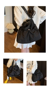 Detail of black drawstring tote bag with adjustable shoulder straps for versatile wear