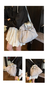 Detail of grey drawstring canvas tote bag with textured nylon fabric and wide strap