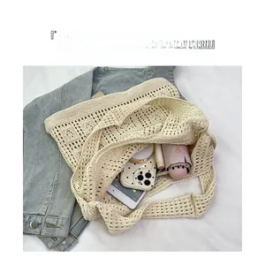 Detail view of cream hollow knit tote bag showing spacious storage for daily essentials