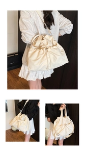 Detail of cream drawstring canvas bag showing the adjustable straps and soft texture