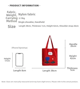 Detailed view of red nylon tote bag with floral embroidery and size comparison reference