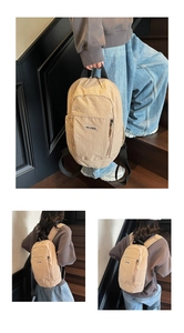 Close-up of khaki outdoor backpack showing textured fabric and black zipper details