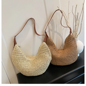 Detailed comparison of beige and khaki woven straw crescent bags with leather straps