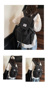 Détail de la texture en nylon durable avec cordon de serrage et rabat du sac à dos noir