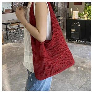 Detailed view of red hollow knit tote bag showing the square woven texture and large size