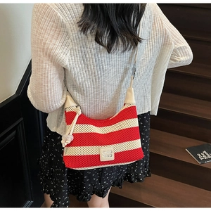 Detail of red and white striped knit hobo bag with CHIO'2ND leather patch and knot charm